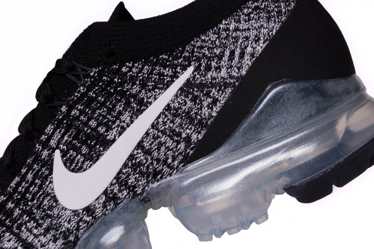 A close up of the Nike Air Vapormax Flyknit 3s. This angle showcases a detailed look into the Air Pods along the sole. Furthermore, this angle also showcases the premium flyknit material.